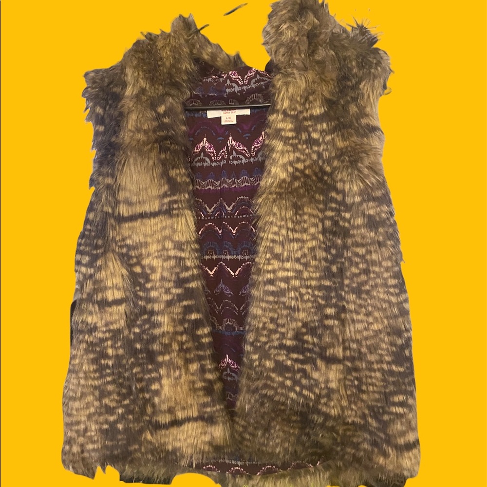 Faux fur vest with hood. Stylish and versatile, can be dressed up or down.
